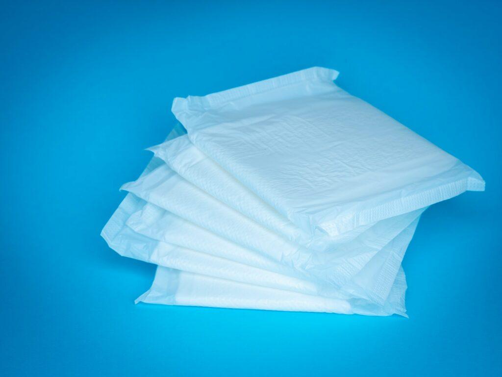 a pile of white tissue sitting on top of a blue table