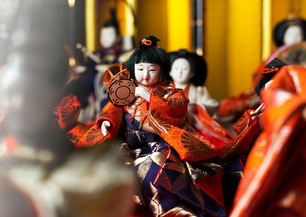 Colorful close-up of traditional Japanese dolls in kimono attire, used in the Hinamatsuri festival.