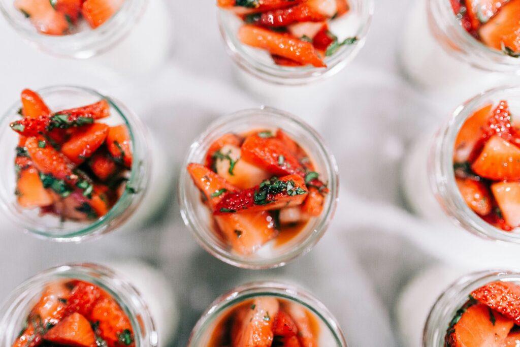 a close up of many small cups of food