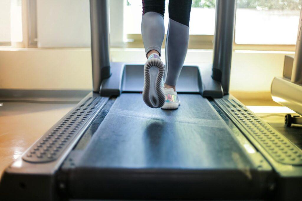 Photo by Andrea Piacquadio Close-up shot of a person exercising on a treadmill, showcasing fitness and health focus.