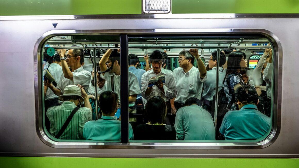 people sitting and standing inside train